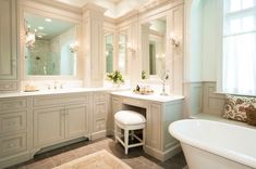 a bath room with a tub a sink and a mirror on the wall next to a window