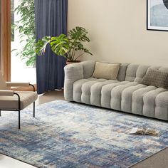 a living room with a couch, chair and rug