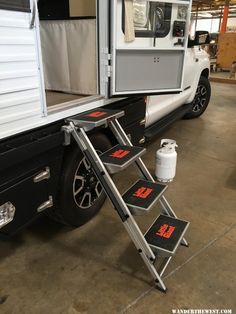 the ladder is attached to the back of a truck that's parked in a garage