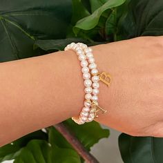 Adorn your wrist with a stylish Freshwater Pearl Initial Charm Bracelet. Featuring freshwater pearls and a clean font initial charm, this bracelet provides both timeless elegance and personalization. It makes the perfect gift for yourself or your loved ones and is suitable for everyday wear or special occasions. Stack it with other bracelets for a stunning layered look. Dimensions: approximately 6.5" before stretch Genuine freshwater pearls 18k gold plated stainless steel initial charm with wate Clean Font, Initial Charm Bracelet, Hair Setting, Pearl Collection, Moissanite Jewelry, Initial Charm, Scrunchie Hairstyles, Steel Jewelry, Layered Look