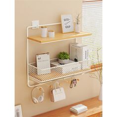 a shelf with two baskets on top of it next to a plant and other items