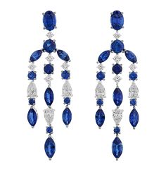 These breathtaking chandelier earrings display an elegant cascade of rich blue sapphires in marquise, oval and round cuts, totaling approximately 5.27 carats. The vivid blue sapphires are beautifully enhanced by 16 sparkling pear and round cut diamonds, totaling approximately 1.38 carats, with F-G color and VS1 clarity. Set in 18K white gold. 1 3/4" length