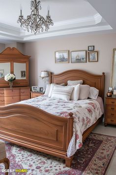 a bed room with a neatly made bed and a chandelier