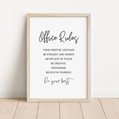 an office rules print in a frame on the floor