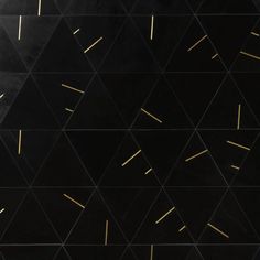 an abstract black and gold geometric background with lines coming out of the top right corner