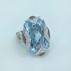 Luxury White Gold Aquamarine Ring, Luxury White Gold Ring With Aquamarine, Luxury Topaz Ring With Diamond Accents, Luxury Blue Diamond Ring With Accents, Luxury Platinum Topaz Ring With Accent Stones, Luxury Light Blue Brilliant Cut Ring, Luxury Light Blue Ring With Brilliant Cut, Designer Diamond Rings With Gemstones, Luxury Blue Gemstones For Formal Occasions