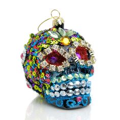 a colorful beaded skull ornament on a white background