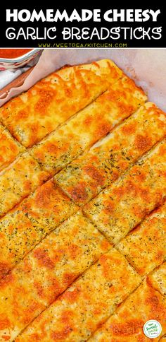 homemade cheesy garlic breadsticks on a baking sheet with text overlay