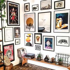 a living room filled with lots of pictures on the wall