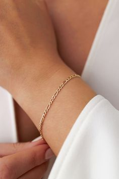 Our new simple and dainty Figaro chain bracelets, as always made in 14k solid gold. You can wear this bracelet with a free mind without worrying about water, perfume, or conditioner contact since real gold never tarnishes.★ Features of the Bracelet (this listing is for a single bracelet only)• Gold Kt: 14K Solid Gold (all pieces are stamped for authenticity)• Available Gold Color: Yellow Gold• Chain Width: 2.5 mm