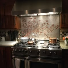 a stove top oven sitting inside of a kitchen next to a wall mounted range hood