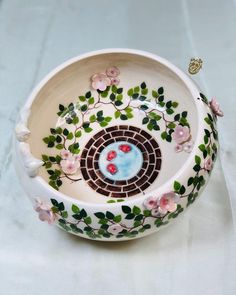 a bowl with flowers and leaves painted on it