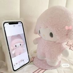 an iphone is next to a stuffed animal