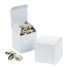 a white box filled with lots of silver colored buttons next to two smaller boxes full of gold colored knobs