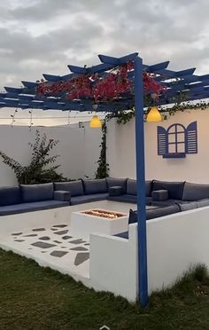 an outdoor living area with blue and white furniture