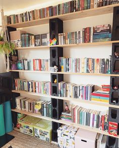 a bookshelf filled with lots of books next to a tv