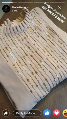 a white shirt with gold sequins on it