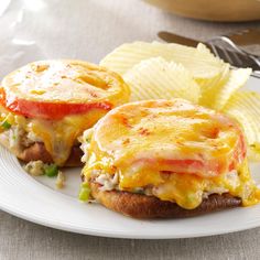 an open faced sandwich with cheese and tomato on it next to potato chips in a bowl