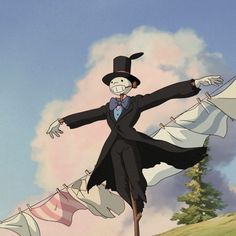 a man in a suit and top hat standing on clothes line with his arms outstretched