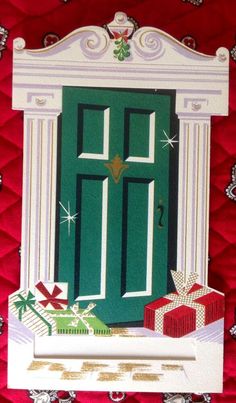 a christmas card with an open green door and presents on the floor next to it