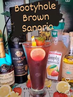 a bottle of boodyhole brown sangria next to a glass filled with liquid