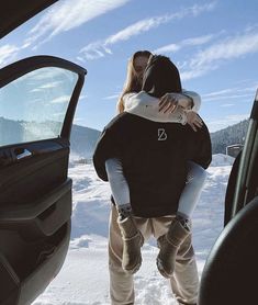 a man and woman kissing in the back of a car