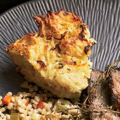 a plate with meat, rice and vegetables on it