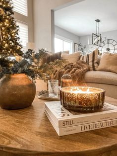 Create a cozy vibe for your coffee table with candles, pinecones, and festive greenery. Perfect for a warm holiday look! Follow for more tips! Living Room Coffee Table Christmas Decor, Christmas Round Coffee Table Decor, Coffee Table Holiday Decor, Christmas Coffee Table Styling, Christmas Centerpieces For Coffee Table, Christmas Decor Ideas Coffee Table, Christmas Decor Ideas For Coffee Table, Coffee Table Styling Christmas, Decorate Coffee Table Ideas