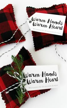 three red and black flannel christmas gift tags with twine on them sitting next to each other