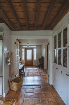 a kitchen with tile flooring and wooden ceiling