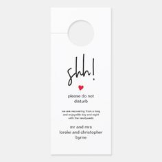 a white door hanger with the words shh and a red heart on it