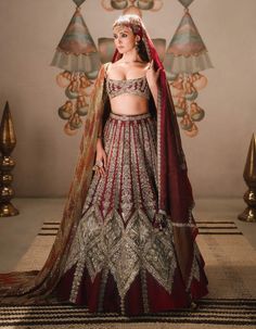 The kokum sherbet lehenga is a grand choice for the bride who wants to stand out. Featuring tissue inlays adorned with son parni, kusum kali, and saad barg motifs, it is complemented by an intricately embroidered red and wine dupatta in a geometric layout. An additional optional heavy naga-tikki embroidered dupatta completes this timeless ensemble, which also includes a separate cancan. Wine Lehenga, Geometric Layout, Embroidered Dupatta, Silk Organza, Only Fashion, Raw Silk, Contemporary Fashion, Trend Setter, Lehenga