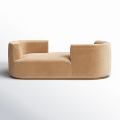 a tan couch sitting on top of a white floor next to a chair with an armrest