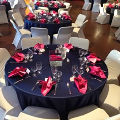 the tables are set with white chairs and red napkins