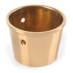 a brass cup with holes in the middle