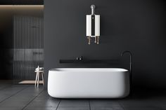 a white bath tub sitting on top of a tiled floor next to a wall mounted faucet