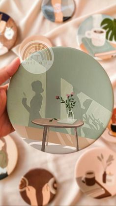 a person holding up a plate with some pictures on it