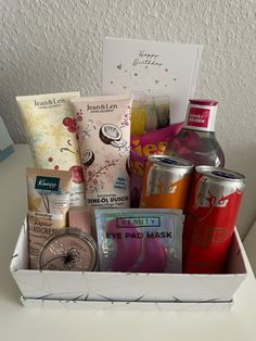 a white box filled with lots of different types of food and drink items on top of a table