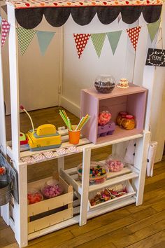 a display case filled with lots of different types of cakes and cupcakes on shelves