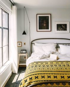 a bed sitting next to a window in a bedroom