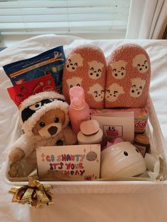 a teddy bear sitting in a basket filled with baby items