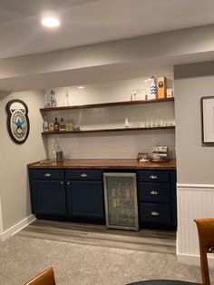 a kitchen with blue cabinets and white walls