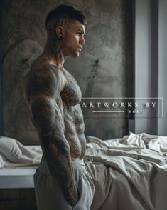 a tattooed man standing in front of a bed with his hands on his hips and looking off to the side