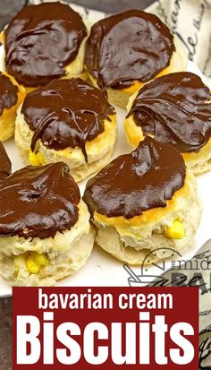 several biscuits with chocolate frosting on them are sitting on a white plate and the words bavaran cream biscuits