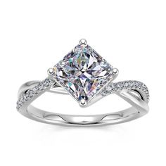 a white gold ring with a princess cut diamond in the center and pave set shoulders