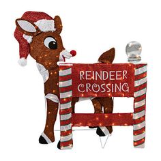 a reindeer is standing next to a sign that says reindeer crossing with lights on it