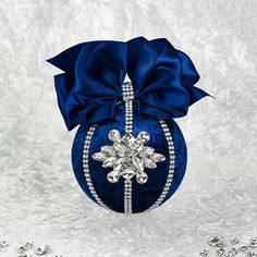 a blue ornament with a snowflake decoration on it's side