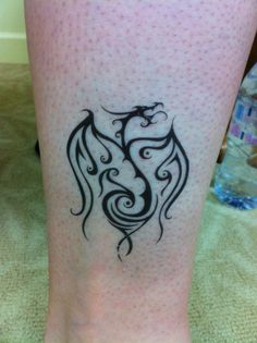 a woman's leg with a tattoo design on it