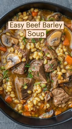 beef barley soup with carrots and mushrooms in a black bowl on a gray surface