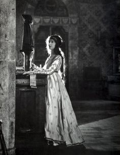 an old photo of a woman in a long dress